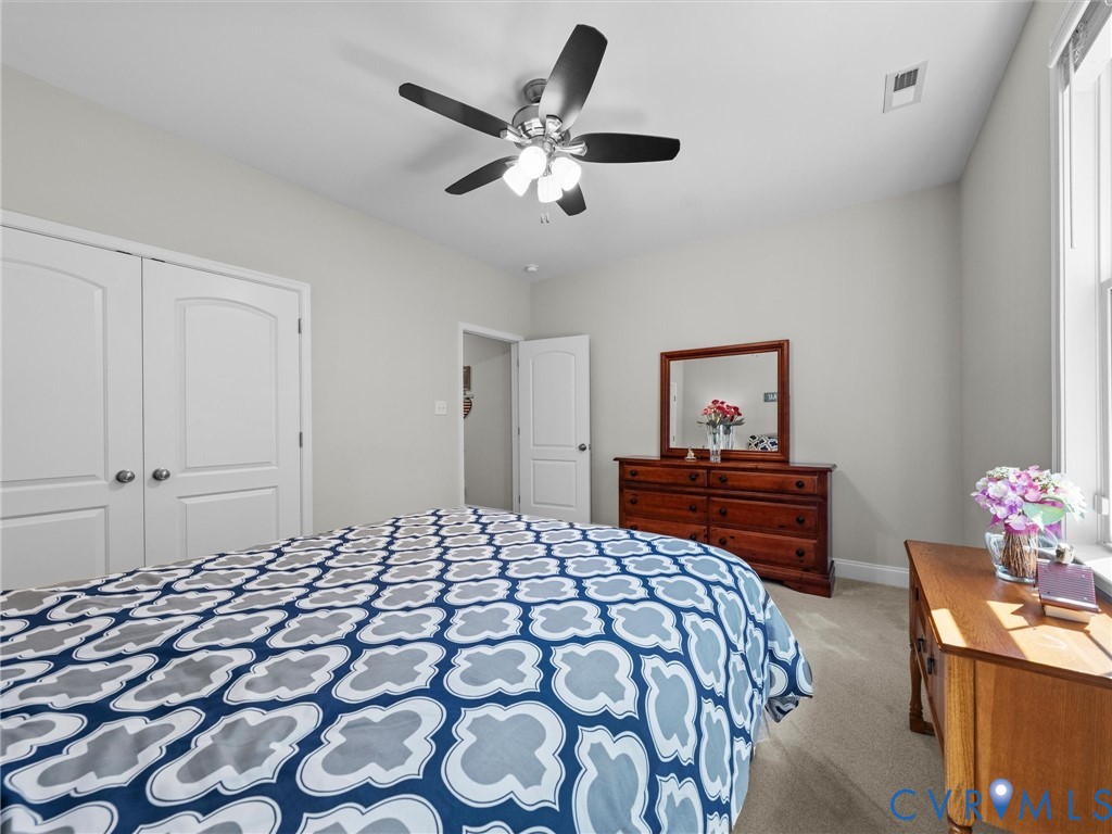 Recessed lighting, ceiling fan with light fixture, double-pane window, and carpeted flooring