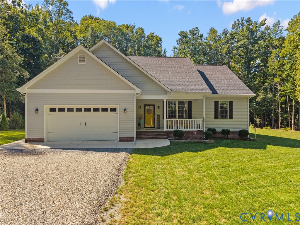 Ranch-style exterior with light gray siding, an attached two-car garage, and a covered front porch with white railings Ranch-style exterior with light gray siding, an attached two-car garage, and a covered front porch with white railings