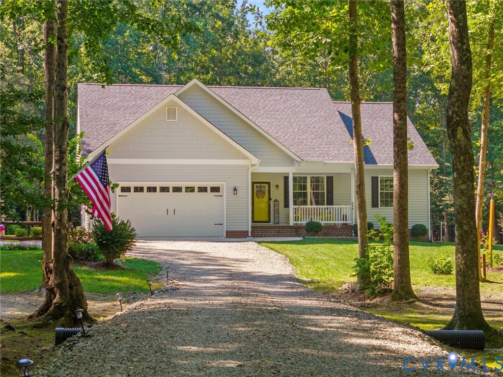 Light blue siding exterior with a covered front porch featuring white railings