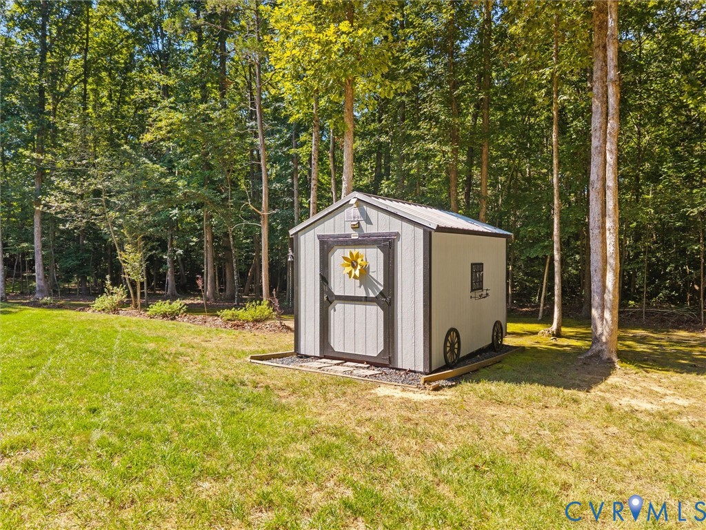Freestanding storage shed with a metal roof and double barn doors