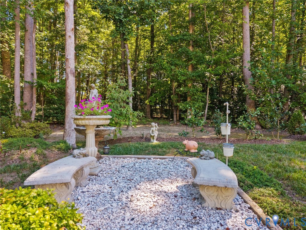 Gravel patio area with two stone benches