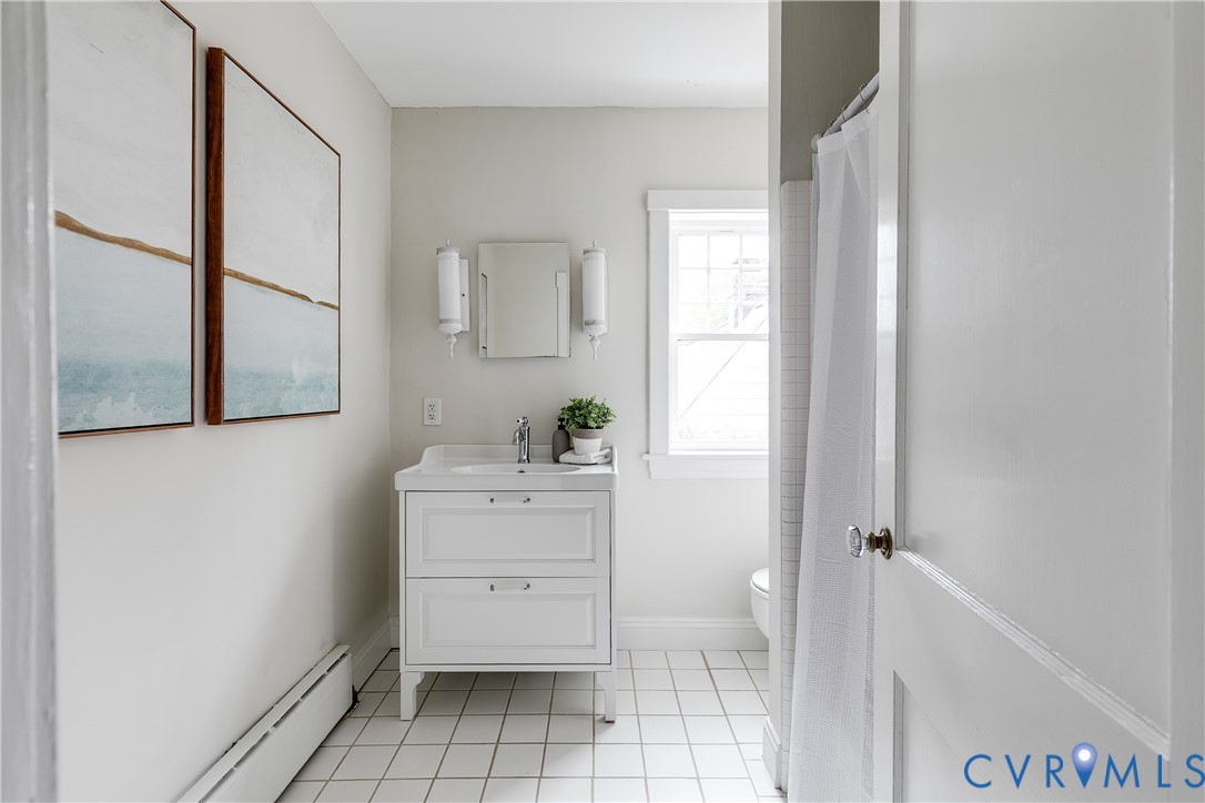 White vanity with integrated sink, chrome faucet, and storage drawers