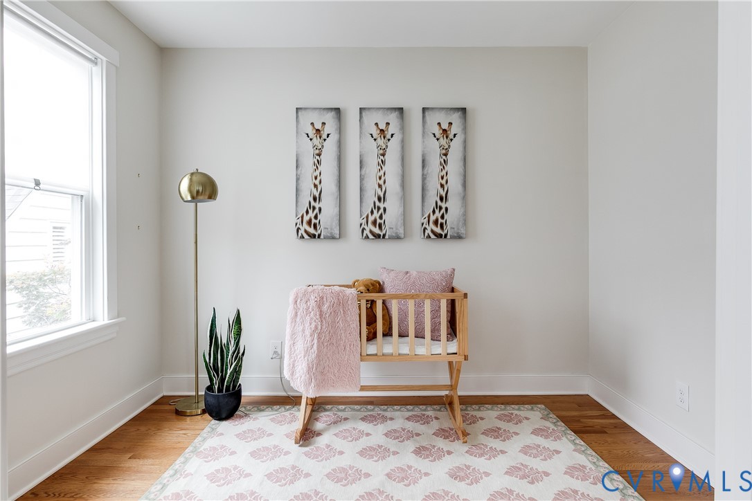Hardwood flooring, painted walls, and a prominent window