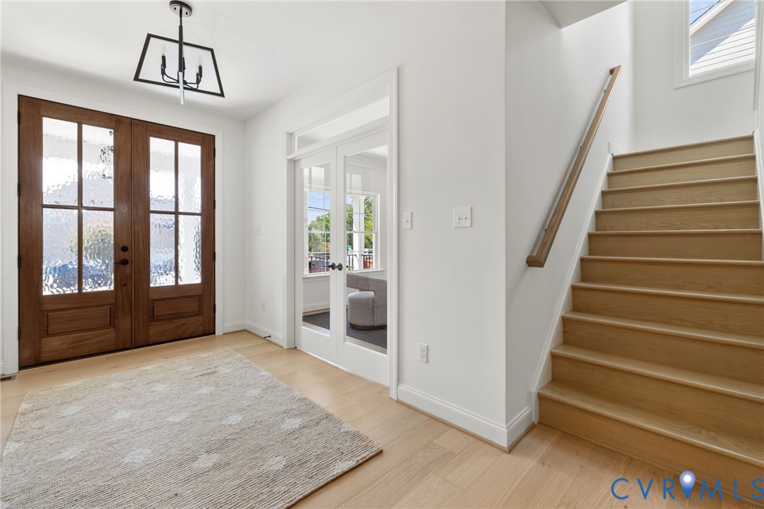 Double wooden entry doors with frosted glass panels