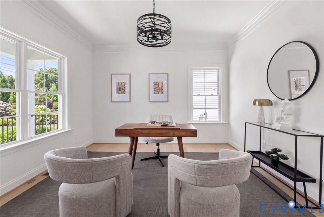 Recessed lighting, crown molding, wood-finish flooring, multiple windows, and a contemporary chandelier