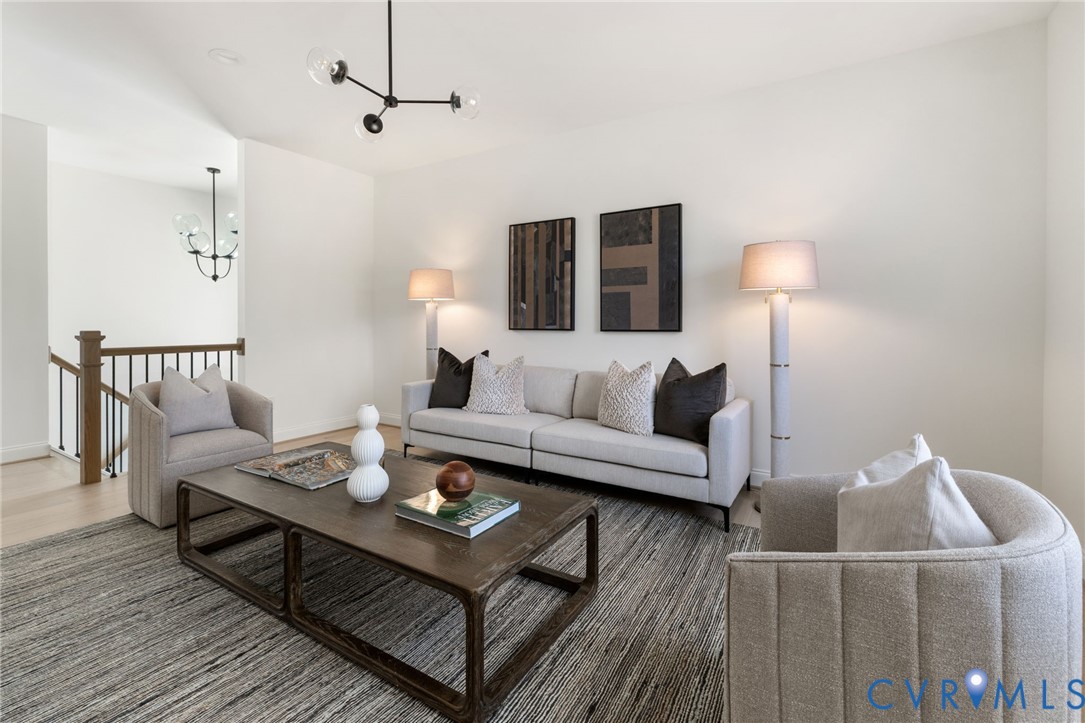 High ceilings with a contemporary chandelier and recessed lighting