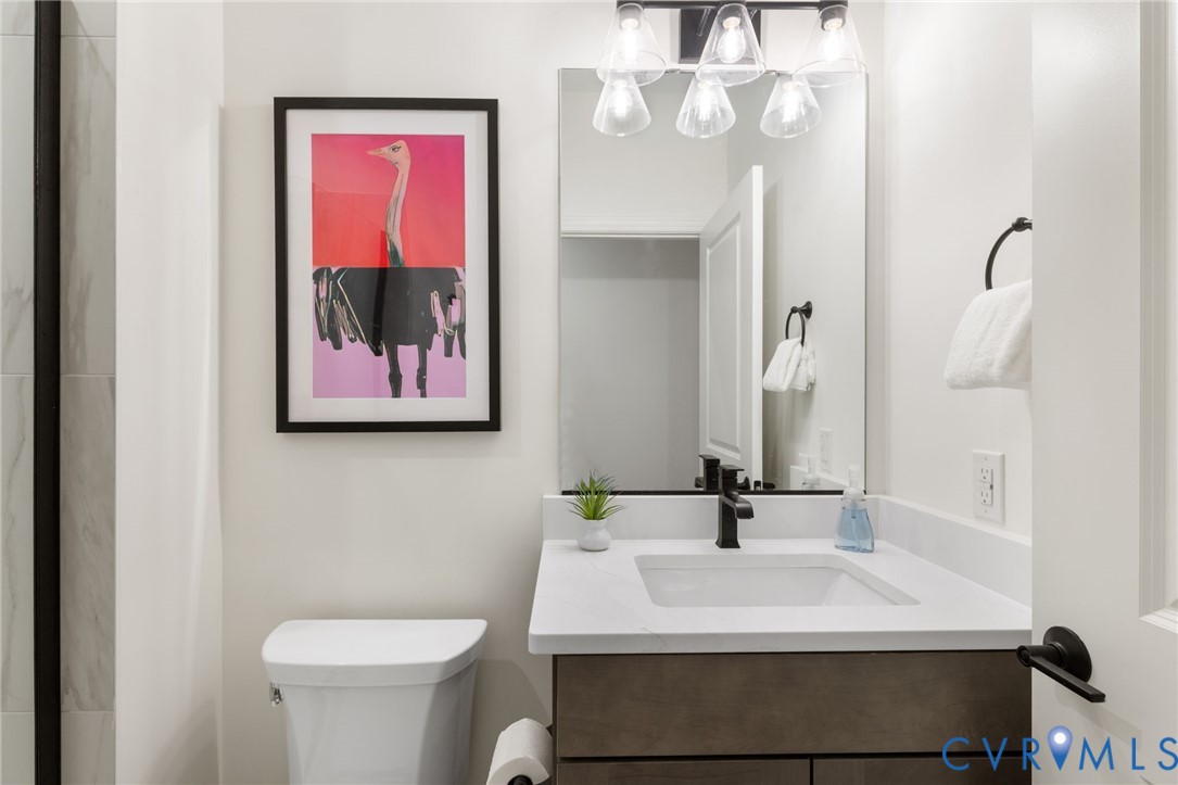 Vanity with a white countertop and integrated sink