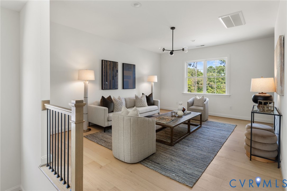 Light-toned wood-finish flooring complements the neutral wall palette