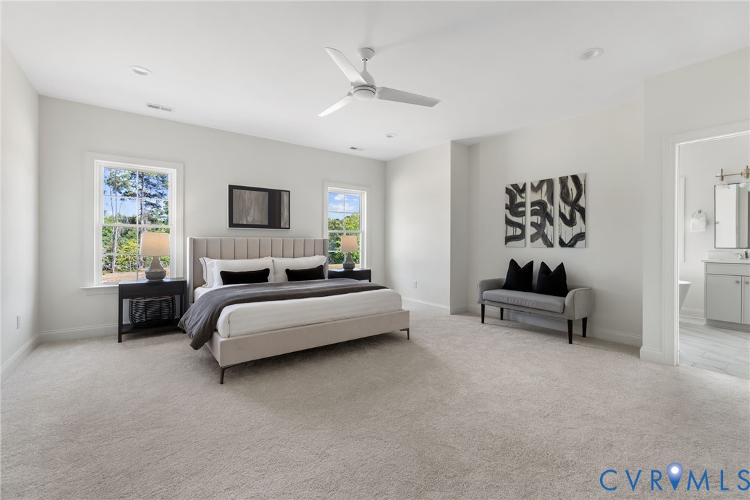 Spacious room with light-toned carpeting and multiple windows
