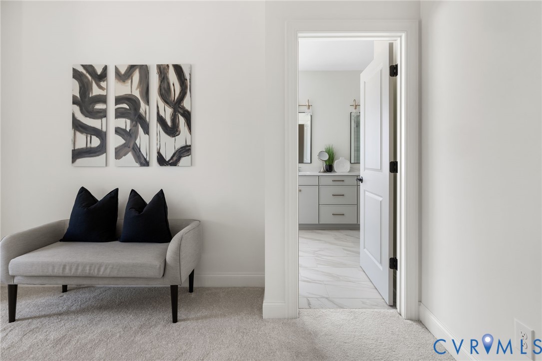 Plush carpeting in a neutral tone, crisp white walls, and a recessed doorway
