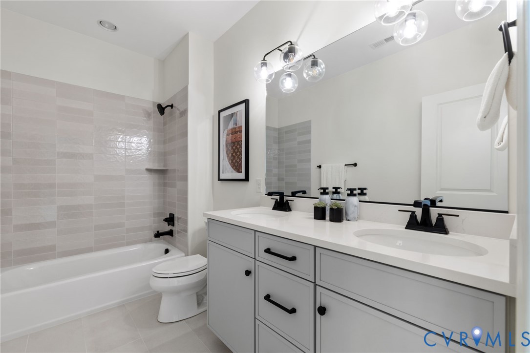 Double vanity with integrated sinks, white countertop, and matte black fixtures