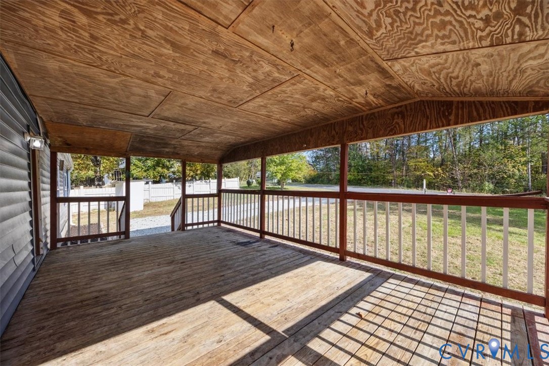 Covered country porch featuring wood-finish flooring and ceiling, and a protective railing