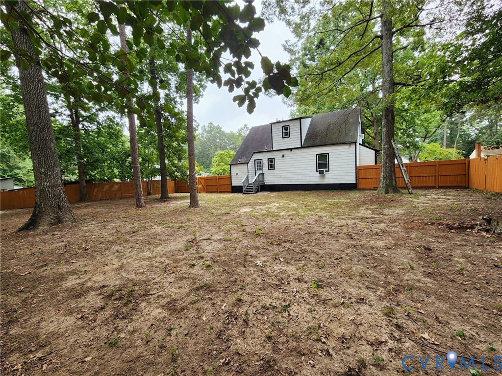 Spacious rear yard with a newly installed wood fence Spacious rear yard with a newly installed wood fence