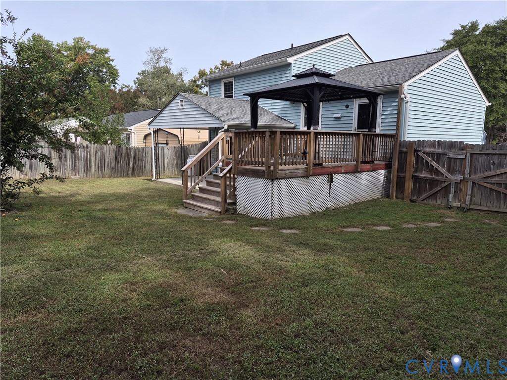 Wood deck with staircase access, featuring a gazebo