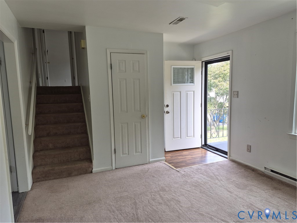 Front entry with wood-finish flooring and security screen door