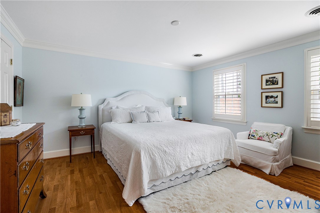 Serene primary bedroom with 2 large closets and private bath; plantation shutters continue throughout 2nd floor.