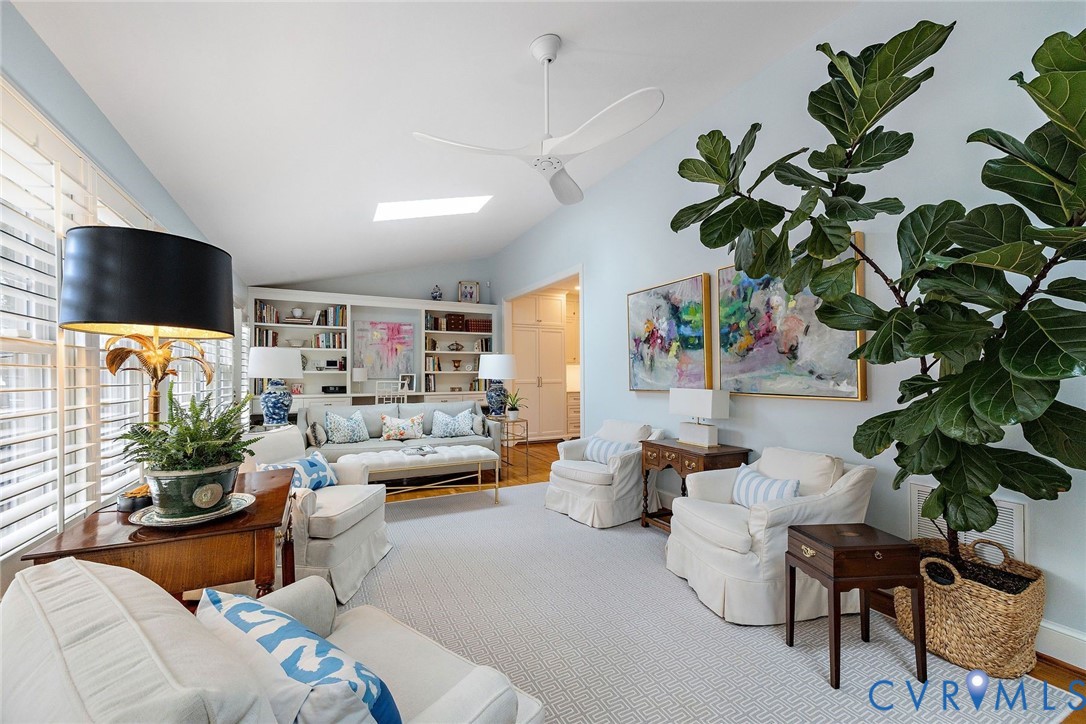 Family room with another wall of custom built-ins and skylights