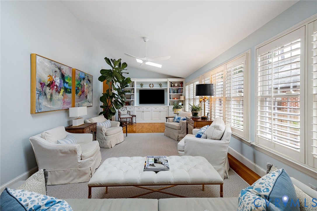 Family room with plantation shutters and wall of custom built-ins