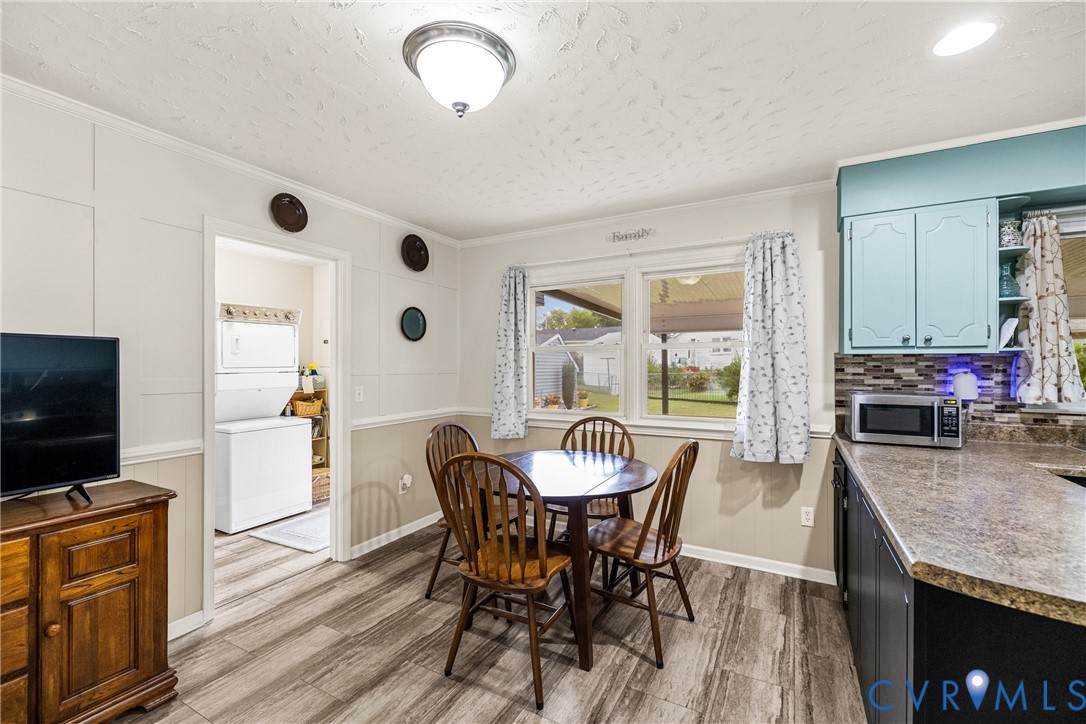 Kitchen dining area featuring wood-finish flooring and a window overlooking the property