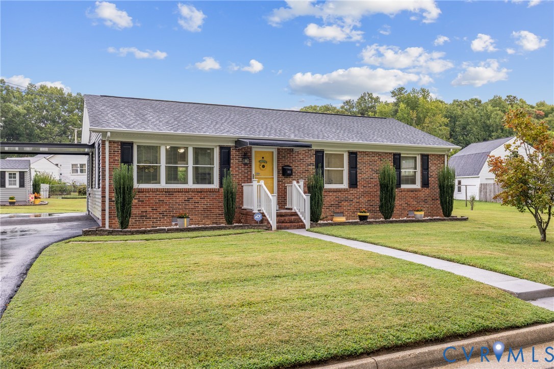 Brick exterior with a shingle roof and white trim