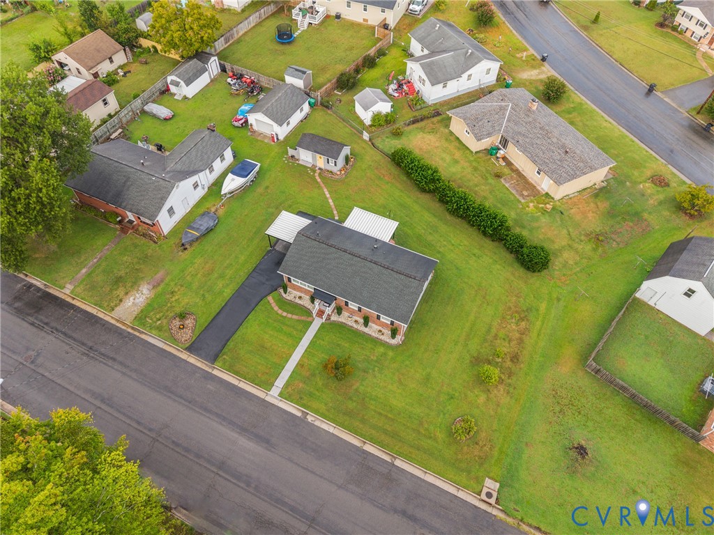 Spacious lot with a paved driveway and an attached carport