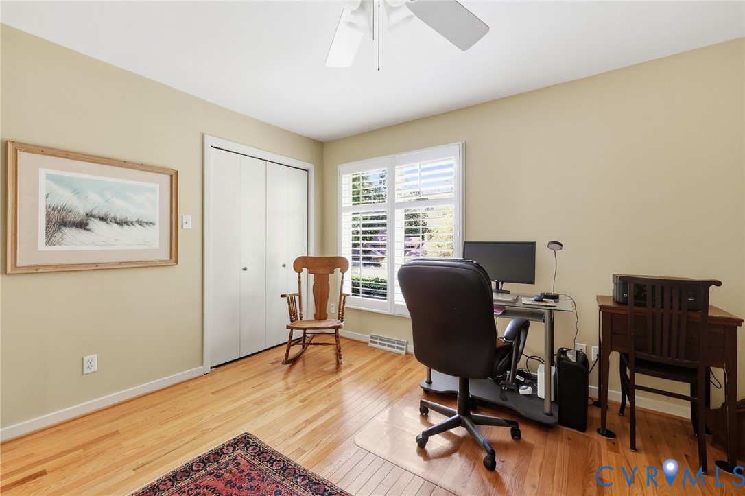 Bedroom 3 features ceiling fan, double closet, hardwood floor.