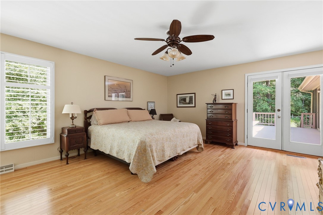 Spacious primary bedroom with lots of natural light, access to deck.