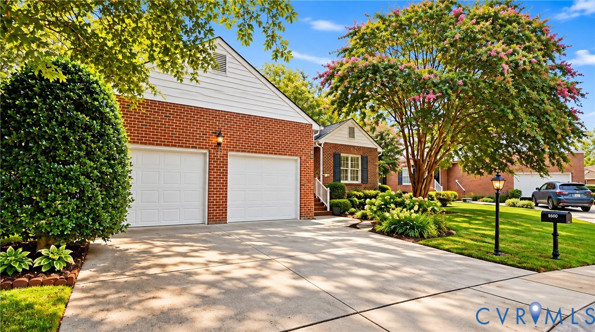 Brick exterior with white siding accents and a two-car garage Brick exterior with white siding accents and a two-car garage
