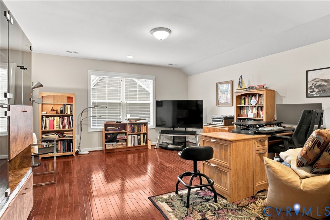 Hardwood flooring, overhead lighting, recessed lighting, and expansive windows with louvered blinds