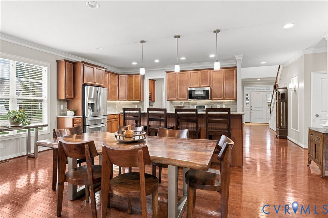Hardwood flooring, recessed lighting, and crown molding