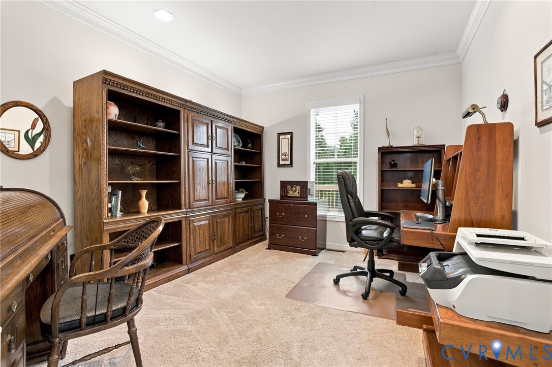 Built-in wood cabinetry, recessed lighting, and crown molding