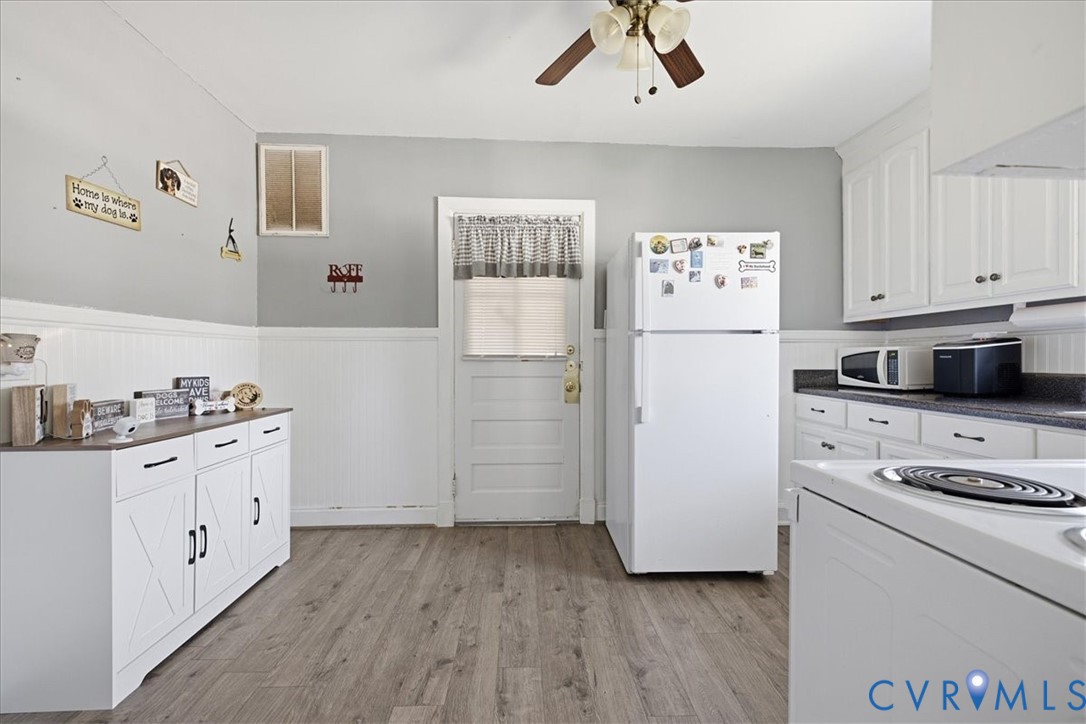 LVP, white wainscoting and upper refinished cabinetry