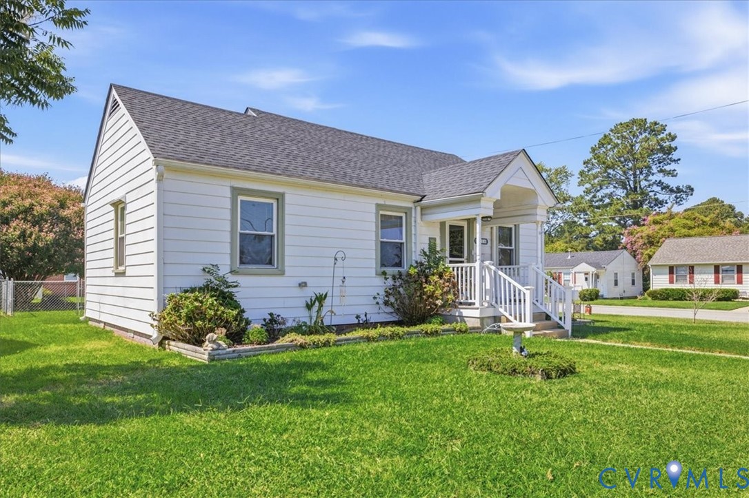White siding exterior  featuring a covered porch entry