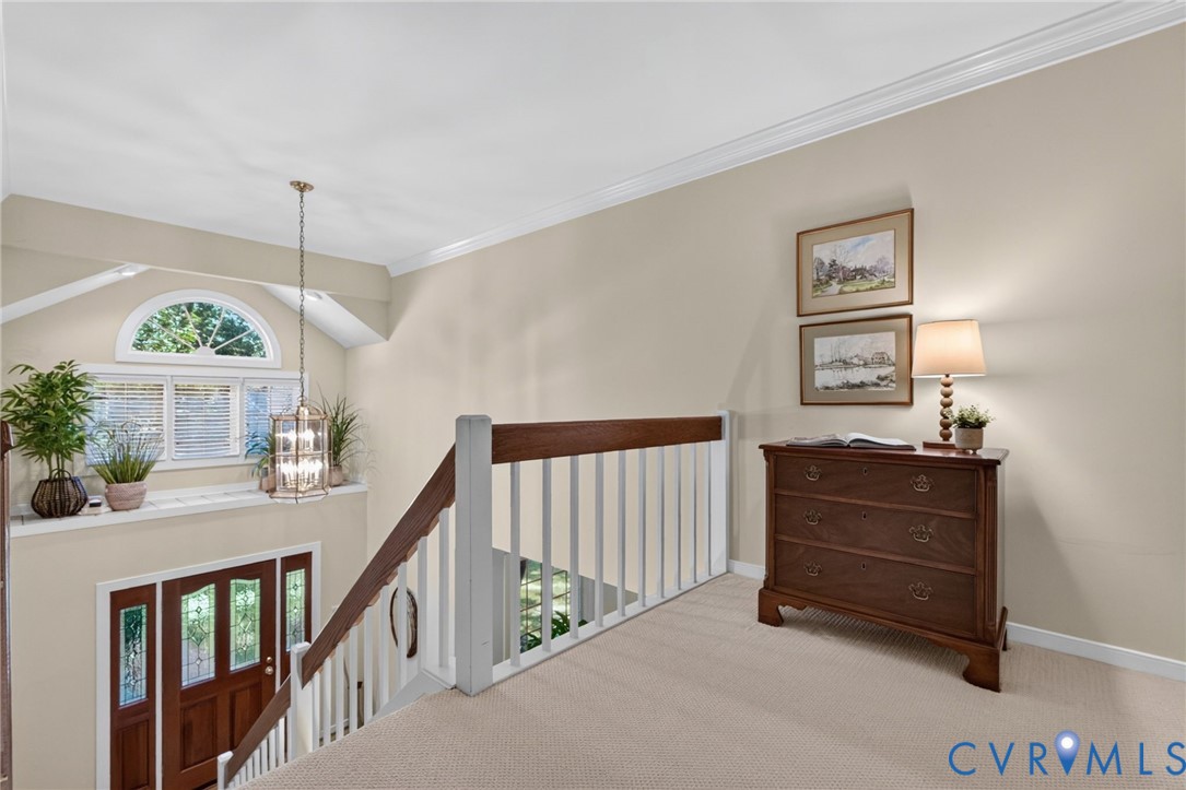2nd floor landing overlooks the 2-story foyer with view of the palladium window.