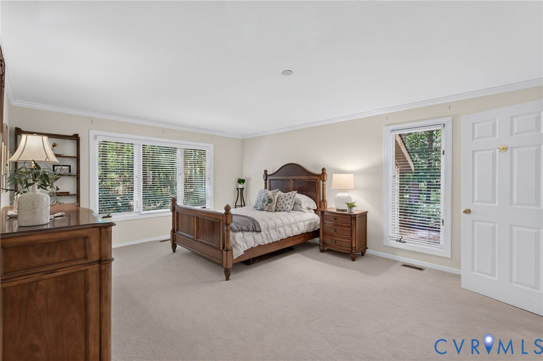 Spacious first floor primary bedroom with walk-in closet and ensuite bath.
