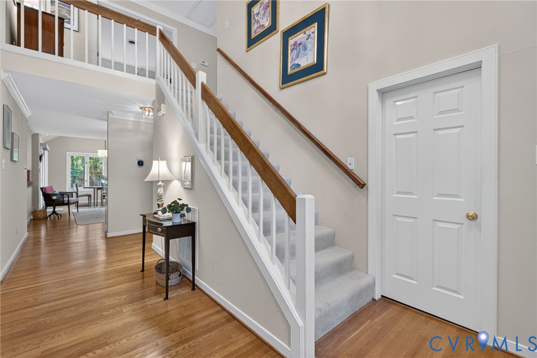 Welcoming 2-story foyer with hardwood floors.