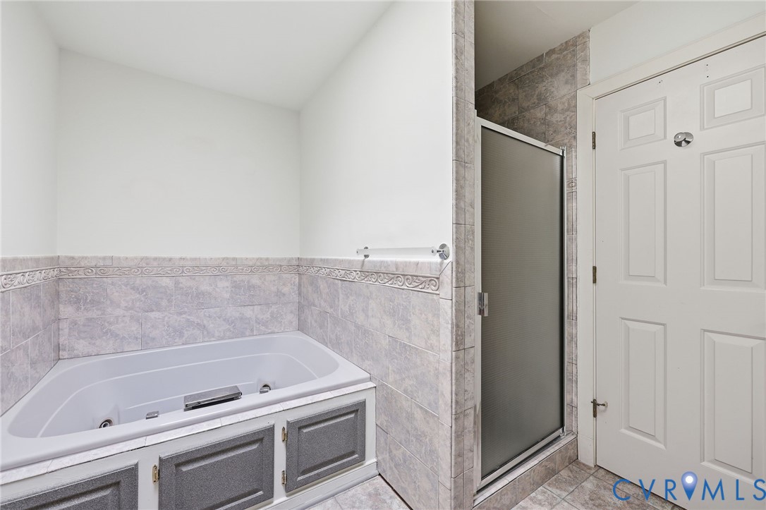 Jacuzzi with tile surround.