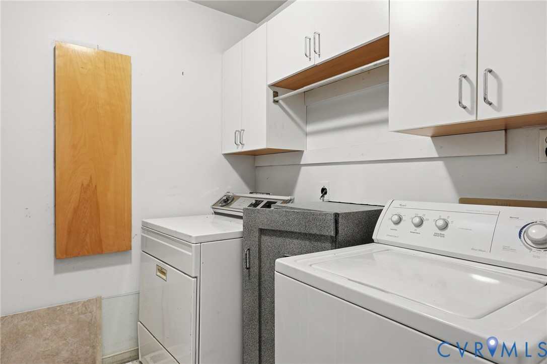 Built-in ironing board, cabinetry, washer/dryer.  Gray cabinet contained stereo equipment -- accessible from family room on the other side of this wall.