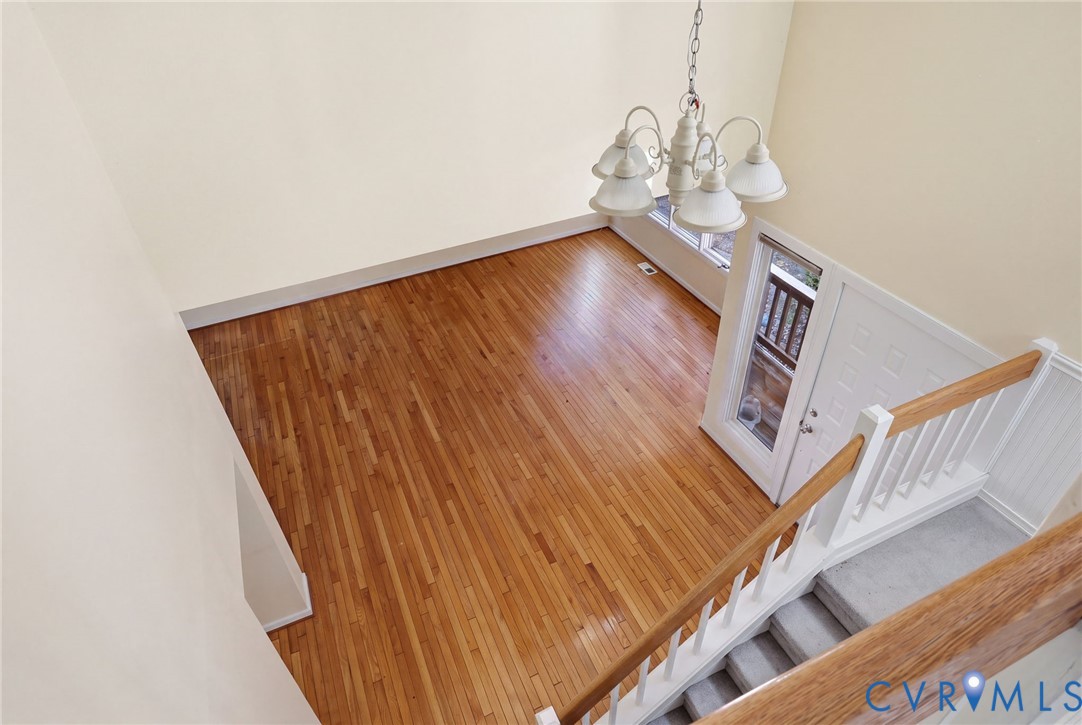 View from top of stairs, looking into living room.
