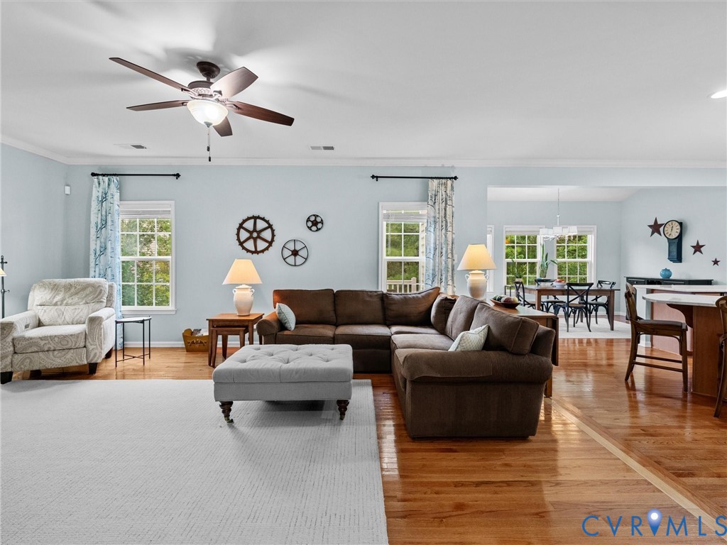 Hardwood flooring, recessed lighting, and a ceiling fan with integrated lighting