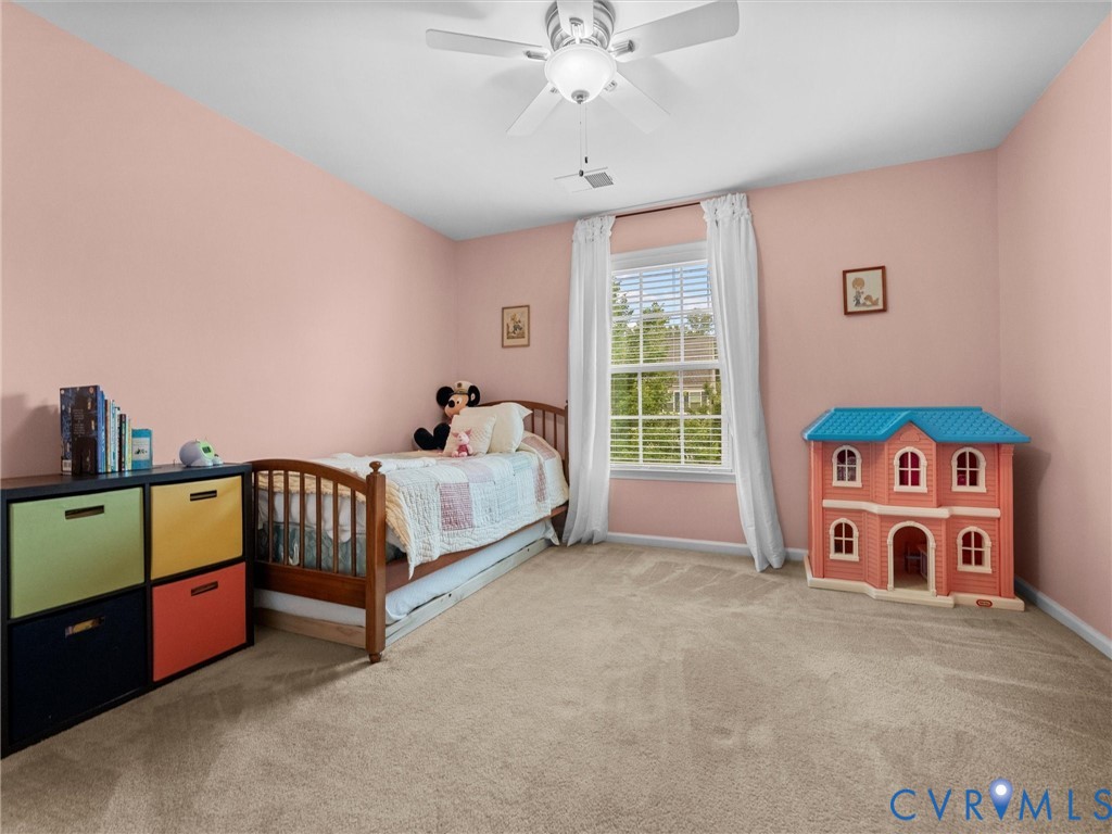 Carpeted room featuring a ceiling fan with integrated lighting, a window with blinds, and white baseboards