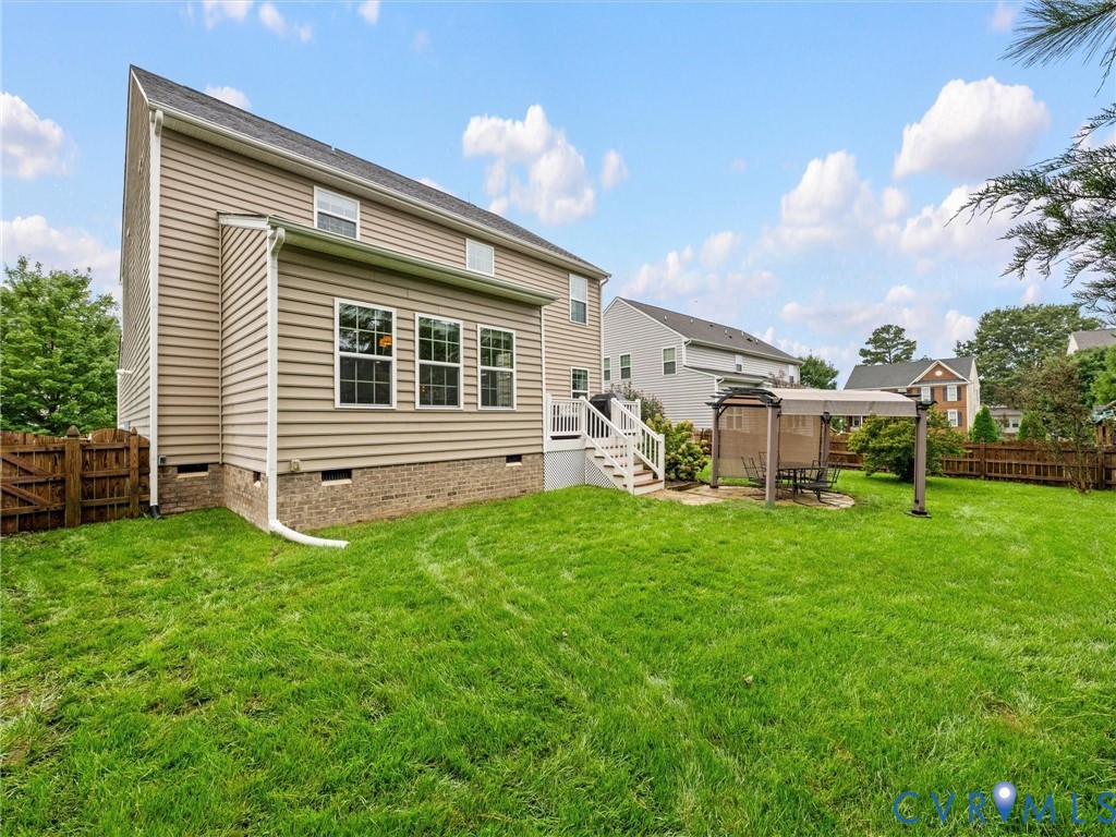 Expansive rear lawn with a partial privacy fence