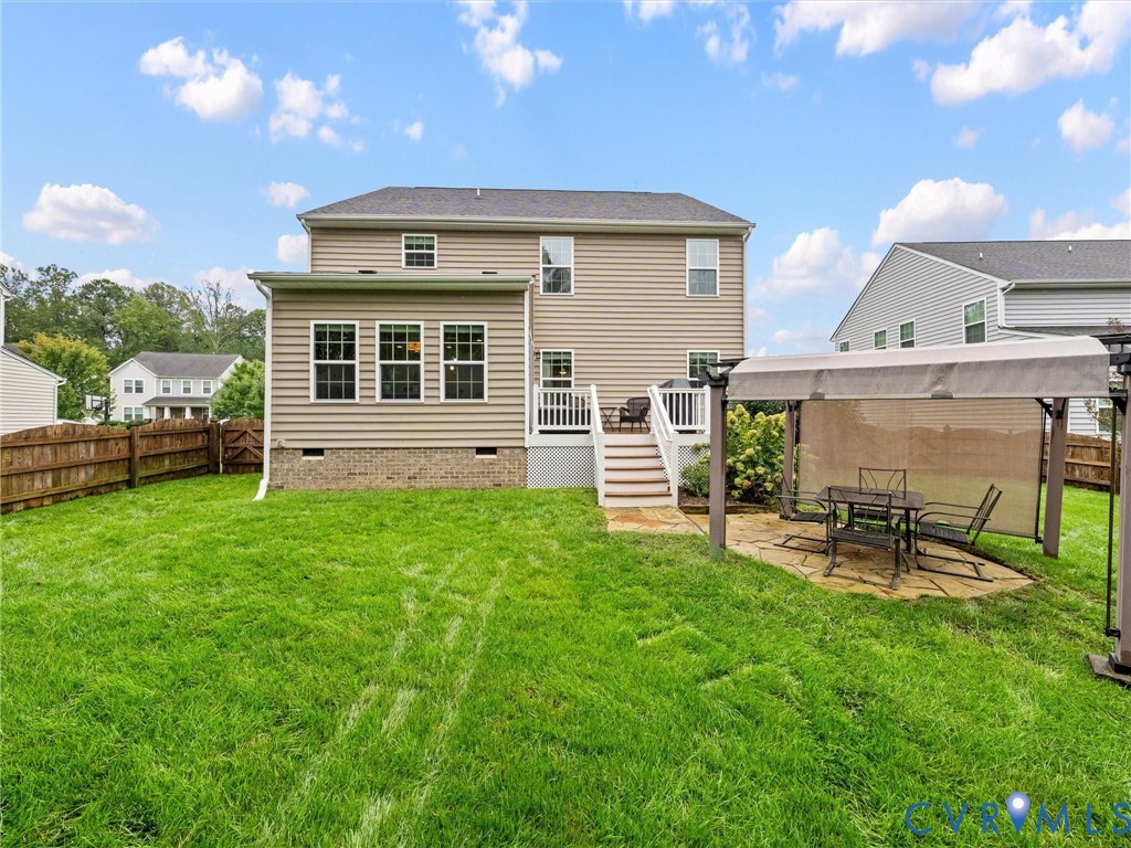 Expansive rear yard with a wooden privacy fence