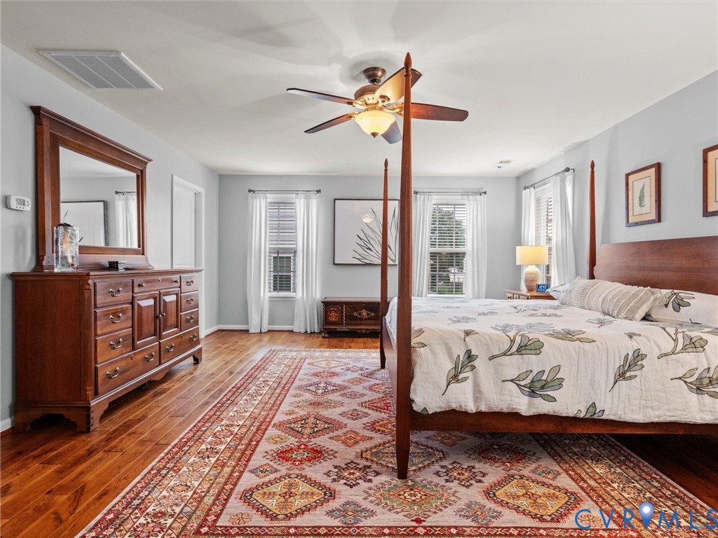 Hardwood-finish flooring, recessed lighting, and a ceiling fan with integrated lighting