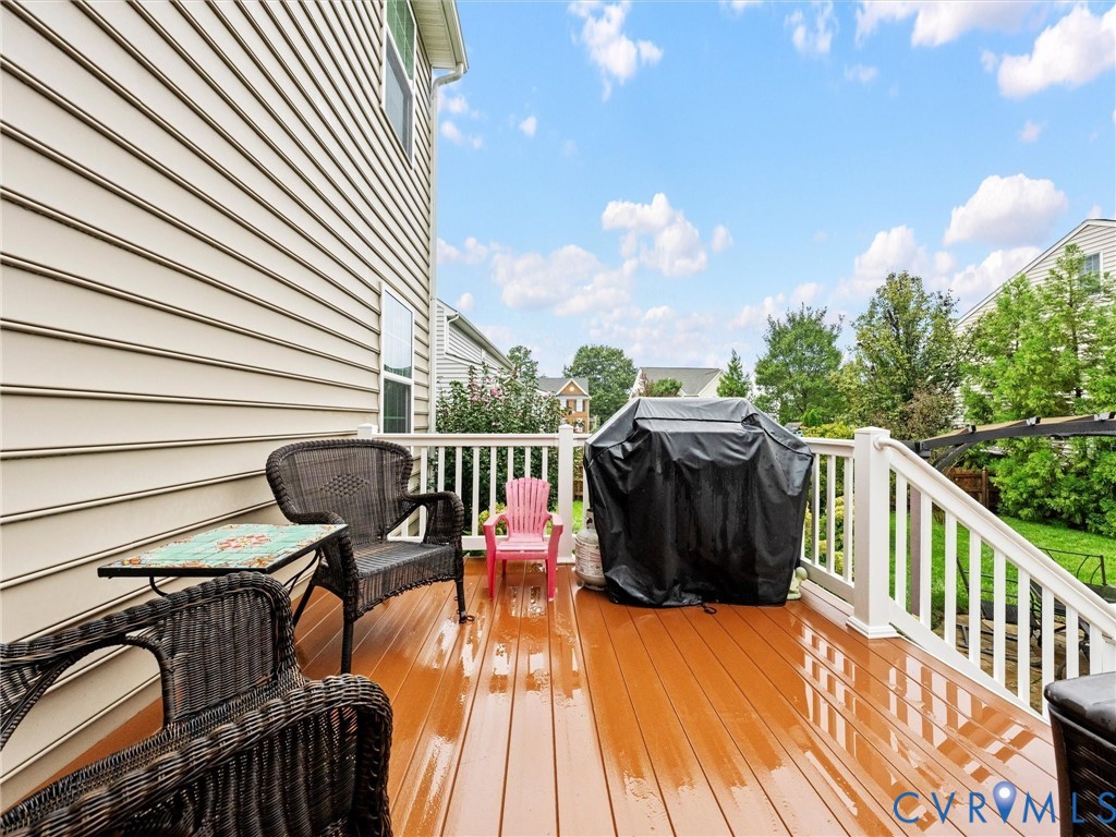 Outdoor deck with wood-finish flooring and white railings