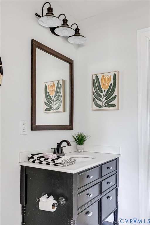 Black vanity with white countertop, undermount sink, and dark bronze faucet