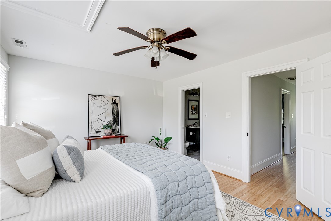 Light wood-finish flooring with white baseboards