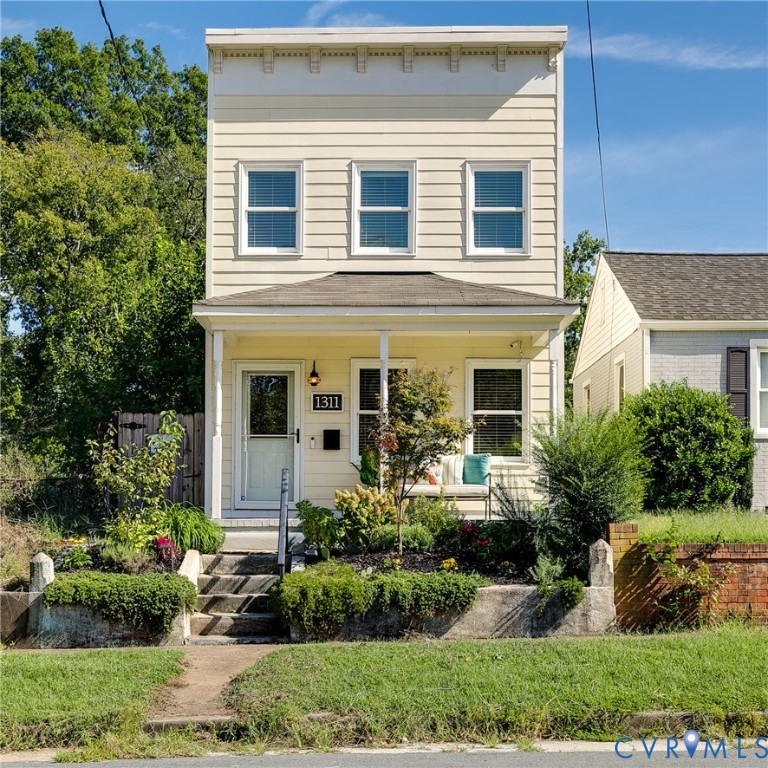 Two-story exterior with horizontal siding and a decorative cornice
