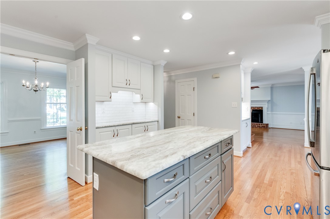 Kitchen island with a light-toned countertop and gray cabinetry