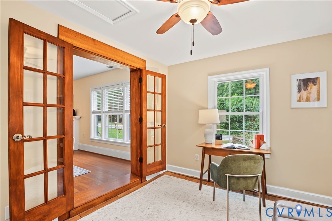 Wood-finish flooring throughout, paired with a ceiling fan with light fixture